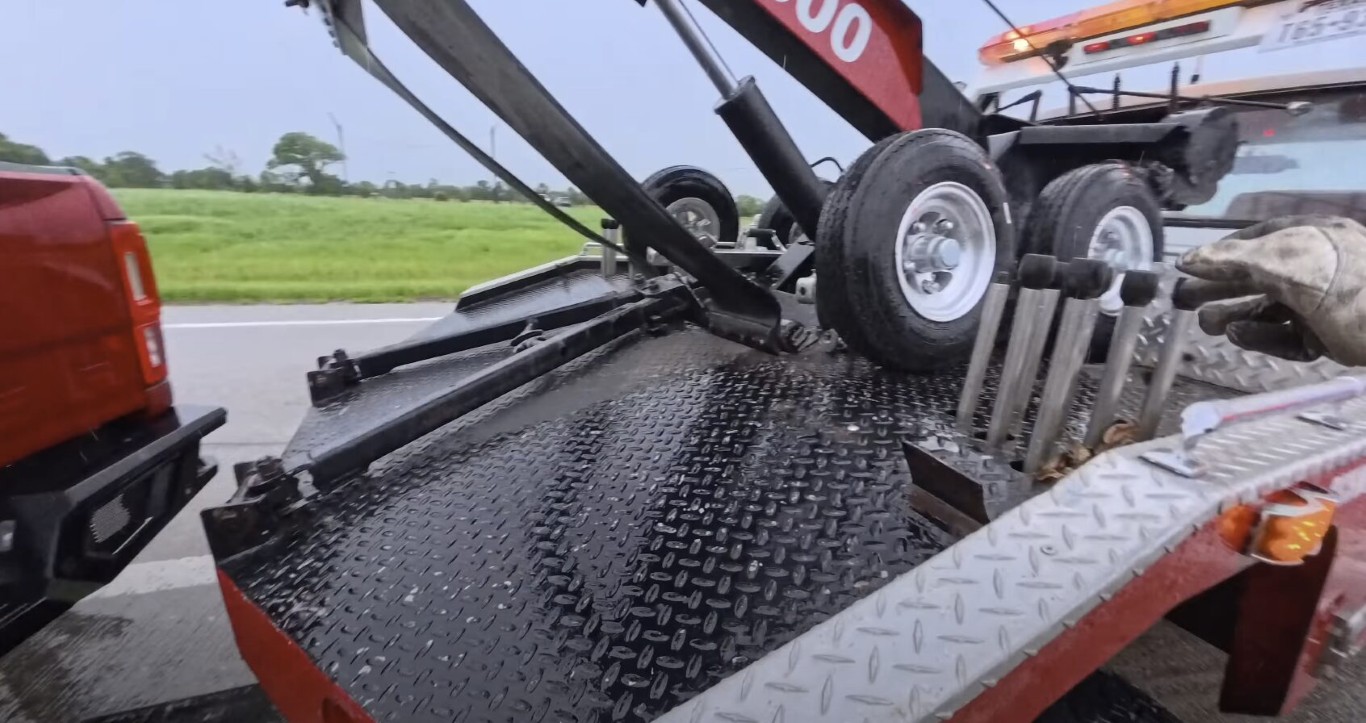 Close-up of tow truck recovery platform with textured non-slip surface